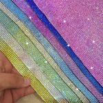 Iridescent rhinestone sheet color display held by hand Iridescent rhinestone sheet color display held by hand