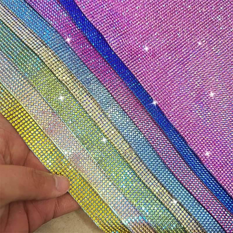Iridescent rhinestone sheet color display held by hand Iridescent rhinestone sheet color display held by hand